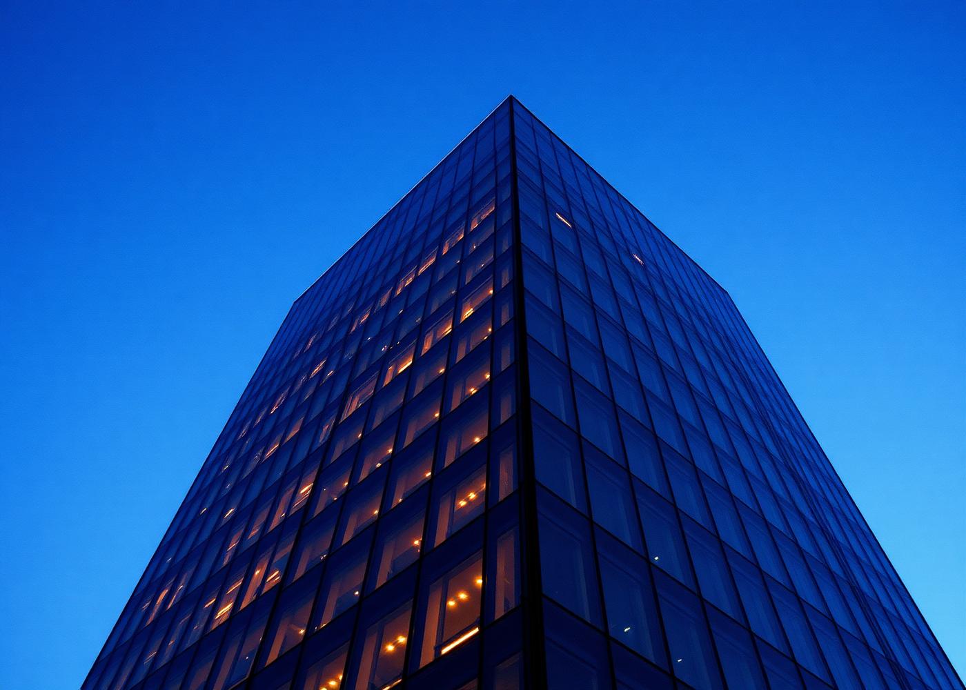 Glass office tower at dusk